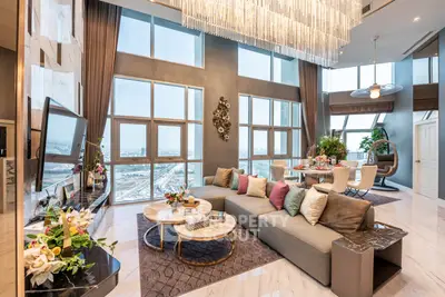 Luxurious living room with high ceilings and panoramic city views.
