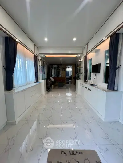 Spacious modern living room with elegant marble flooring and stylish decor