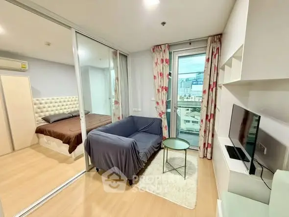 Modern apartment living room with glass wall bedroom and city view balcony.