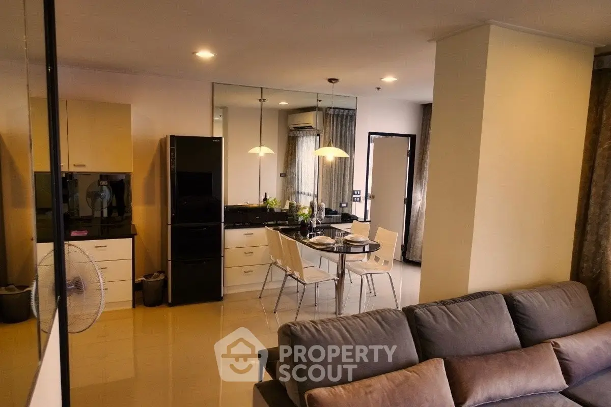 Modern open-plan living room and kitchen with sleek design and cozy ambiance