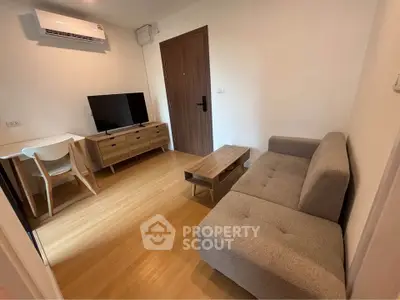 Modern living room with stylish furniture and wooden flooring in a cozy apartment.