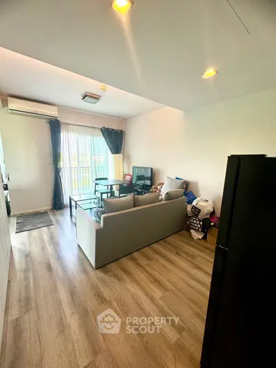 Spacious living room with modern decor and large windows for natural light.