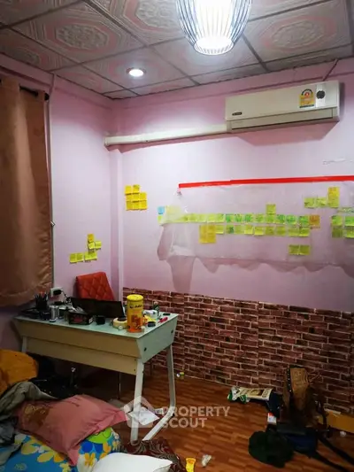 Cozy study room with air conditioning and creative wall decor, perfect for productivity and comfort.
