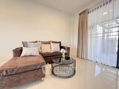 Stylish living room with modern sofa and elegant decor, featuring floor-to-ceiling windows for natural light.