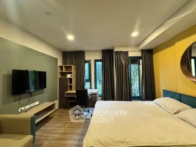 Modern bedroom with stylish decor, featuring a large bed, wall-mounted TV, and a study desk by the window.
