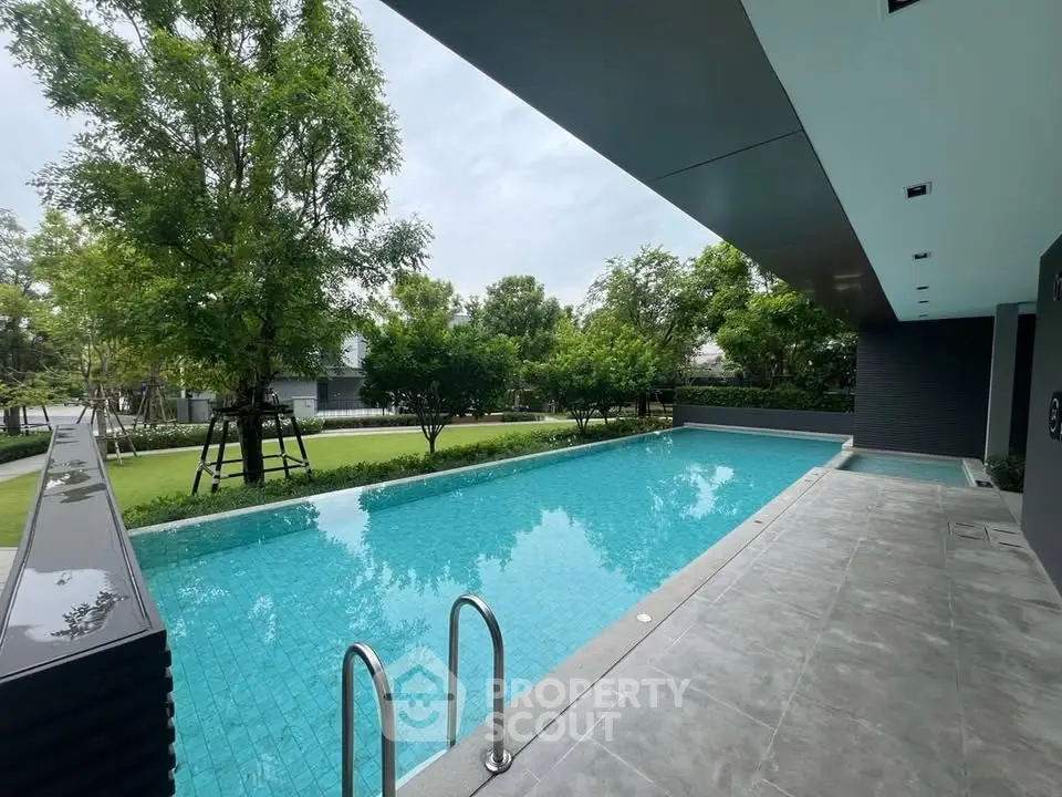 Luxurious outdoor pool area with lush greenery and modern design, perfect for relaxation and leisure.