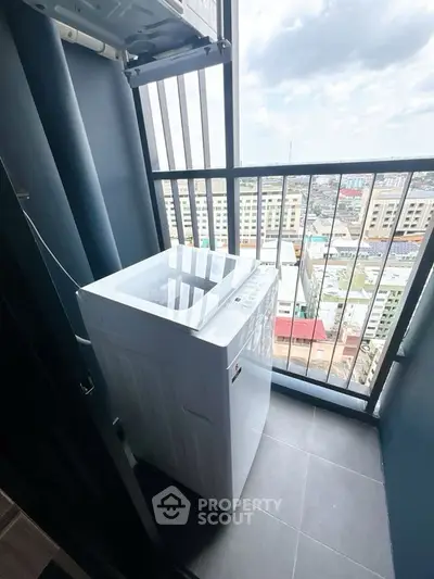 Modern apartment balcony with washing machine and city view