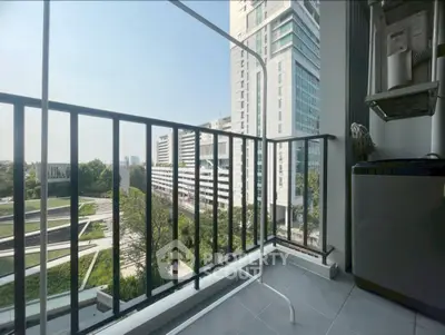 Modern balcony with city view and sleek railing in high-rise building