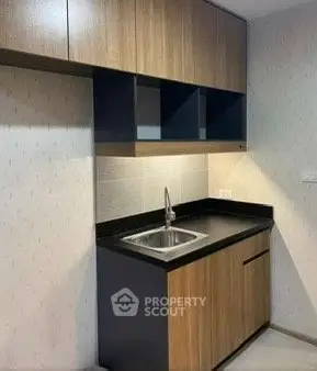 Modern kitchen with sleek cabinetry and built-in sink, perfect for contemporary living.