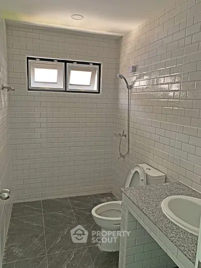Modern bathroom with white subway tiles and sleek fixtures