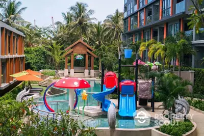 Luxurious condo with vibrant pool and play area surrounded by lush greenery.