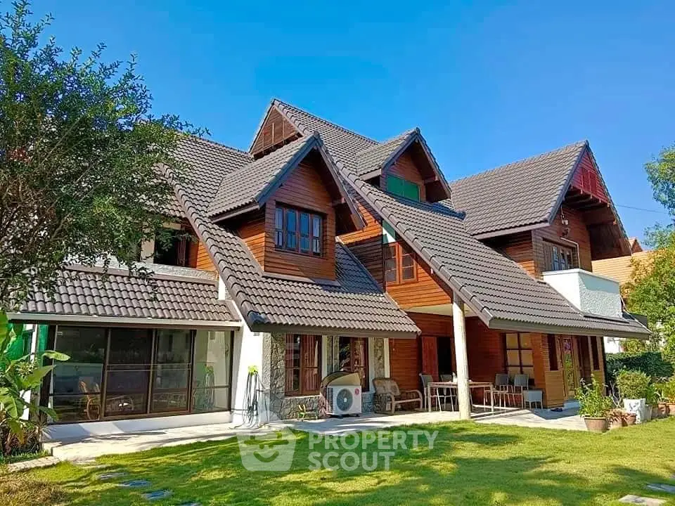 Charming wooden house with lush garden and modern design under clear blue sky.