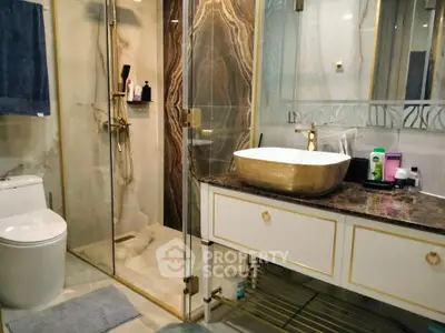 Luxurious bathroom with gold accents and modern fixtures