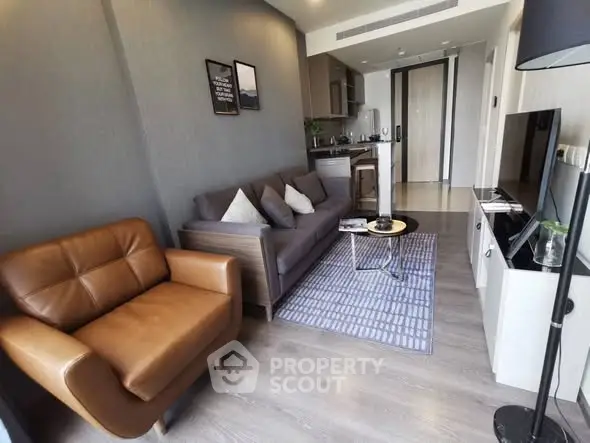 Modern living room with stylish furniture and open kitchen layout