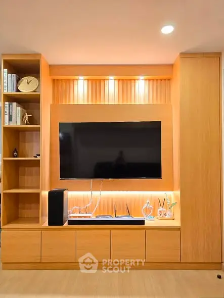 Modern living room with sleek wooden TV unit and ambient lighting