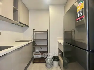 Modern kitchen with sleek cabinets and stainless steel fridge