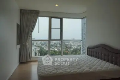 Spacious bedroom with panoramic city view and modern decor