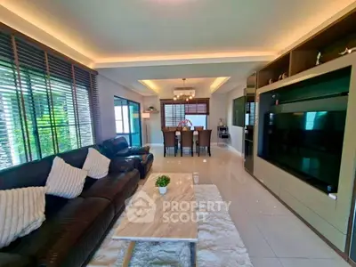 Spacious modern living room with elegant decor and large TV unit, perfect for family gatherings.