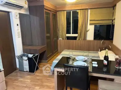 Cozy studio apartment with dining area and modern furnishings, perfect for urban living.