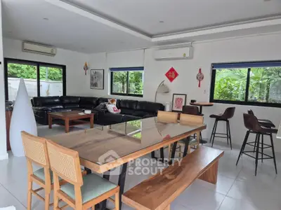 Spacious modern living room with large windows and stylish furniture