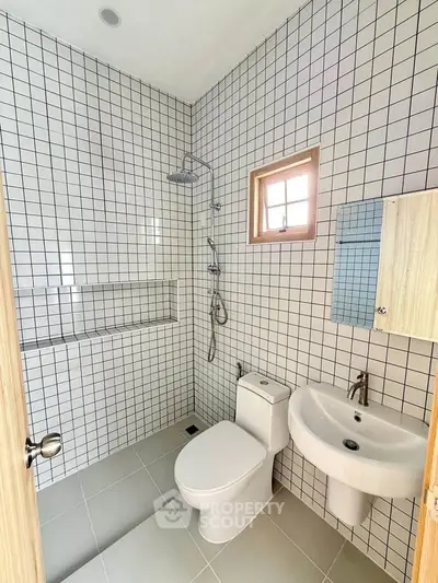 Modern bathroom with sleek white tiles and contemporary fixtures