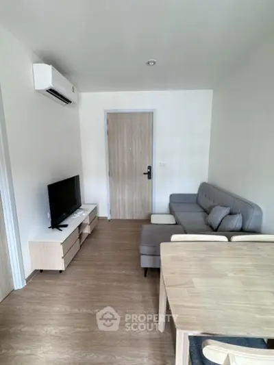 Modern living room with sleek furniture and air conditioning unit