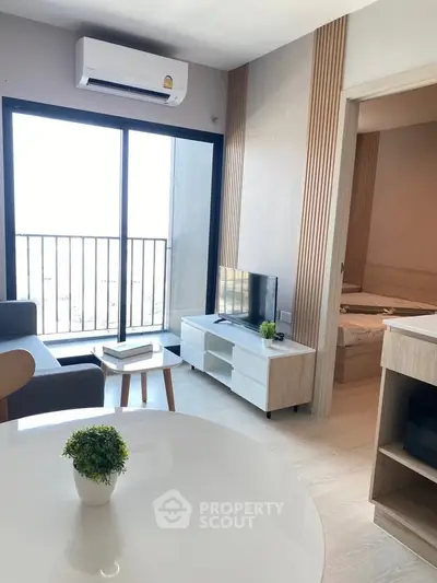 Modern living room with balcony access and stylish decor in a contemporary apartment.
