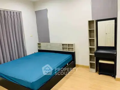 Spacious bedroom with modern furnishings and ample natural light, perfect for relaxation and comfort.