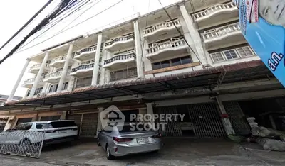 Spacious multi-story building with parking in urban area, ideal for commercial or residential use.