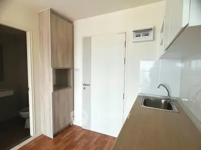 Modern kitchen with sleek cabinetry and wooden countertops in a compact layout.