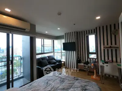 Modern bedroom with city view and balcony access in high-rise apartment