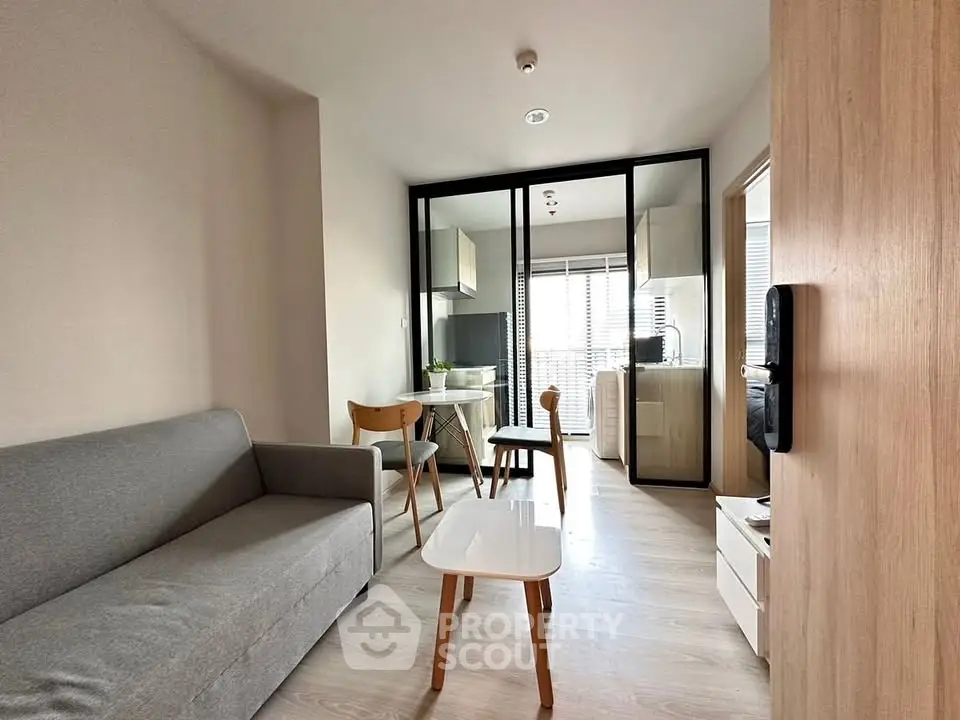 Modern living room with open kitchen layout and stylish furniture