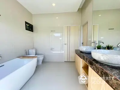 Luxurious modern bathroom with dual sinks and elegant bathtub