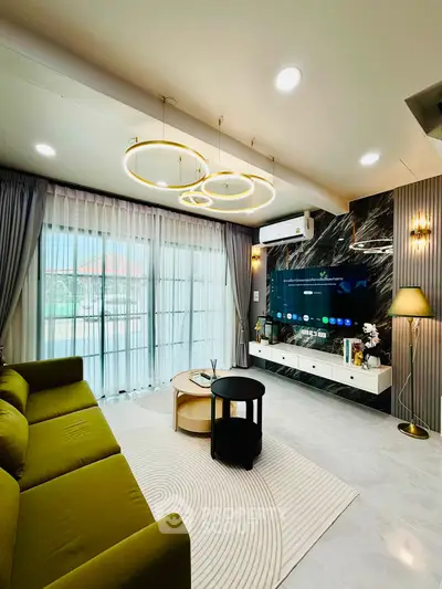 Luxurious living room with modern decor, stylish lighting, and large windows for natural light.