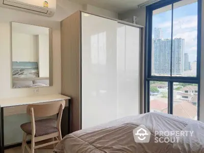 Cozy bedroom with city view, modern wardrobe, and study desk in urban apartment