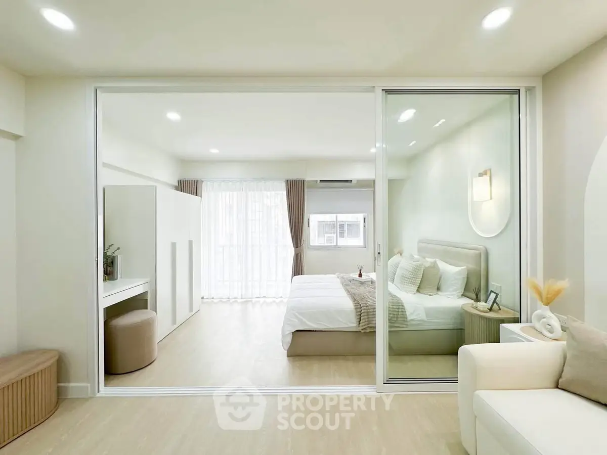 Modern bedroom with glass partition and elegant decor in a bright apartment