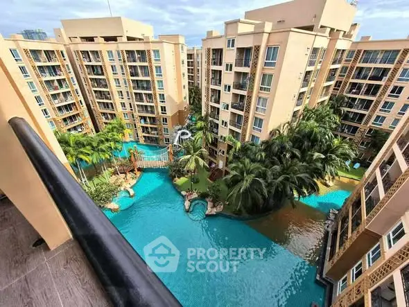 Luxurious resort-style apartment complex with stunning pool view and lush greenery.
