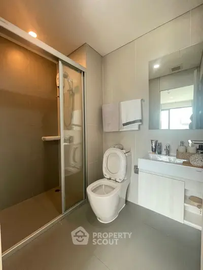 Modern bathroom with sleek shower and contemporary fixtures.