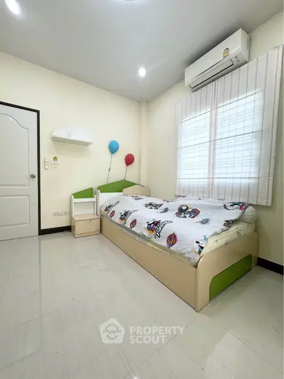 Cozy bedroom with modern decor and air conditioning, perfect for relaxation.