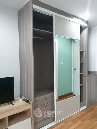 Modern bedroom with built-in wardrobe and sleek TV stand