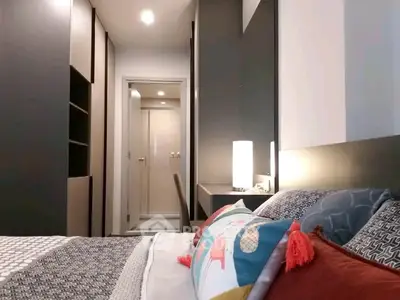 Modern bedroom with stylish decor and cozy lighting in a contemporary apartment.