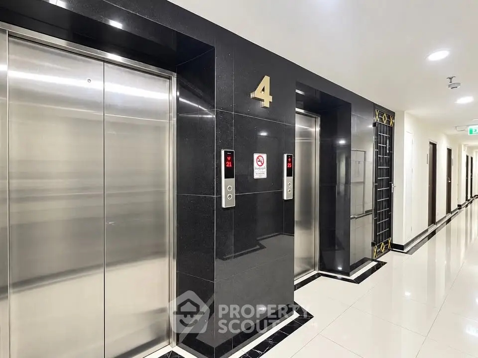 Modern building elevator lobby with sleek design and polished floors on the fourth floor.