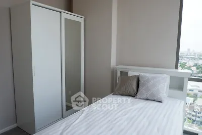 Modern bedroom with sleek wardrobe and city view, perfect for urban living.