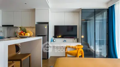 Modern living room with sleek kitchen and vibrant decor in open layout apartment.