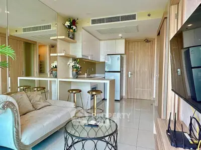 Modern open-layout living room with stylish kitchen and elegant decor in a luxury apartment.