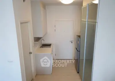 Modern compact kitchen with sleek design and integrated appliances.