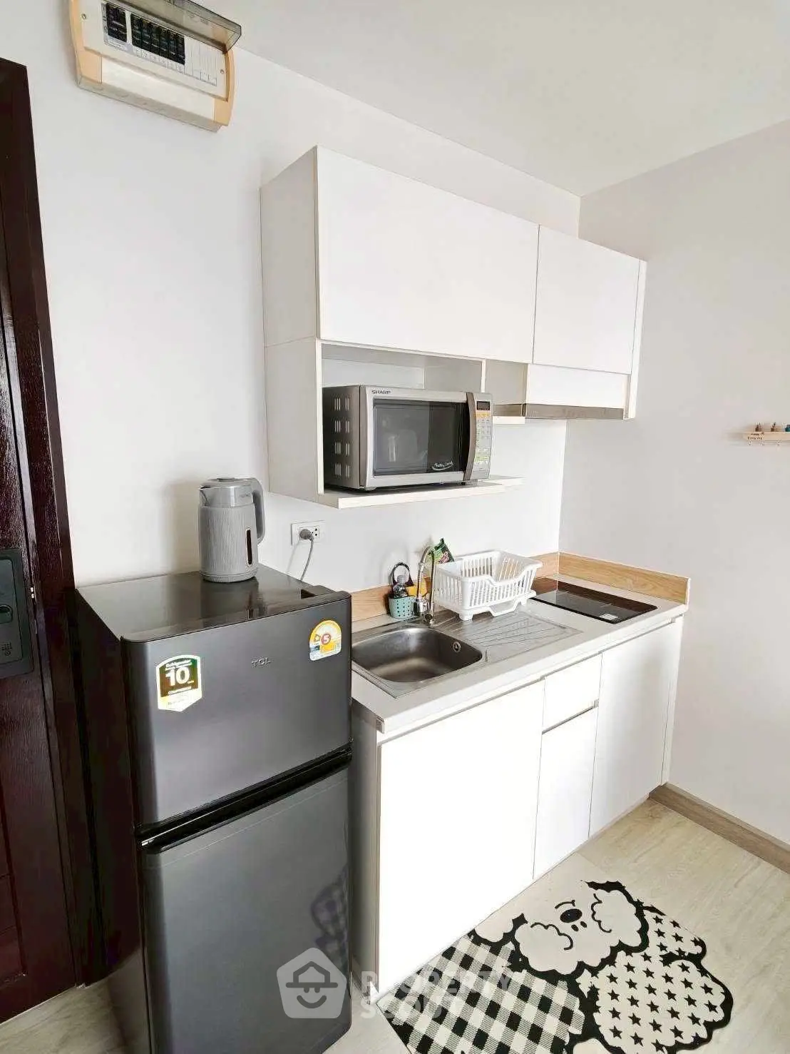 Compact modern kitchen with sleek appliances and stylish decor