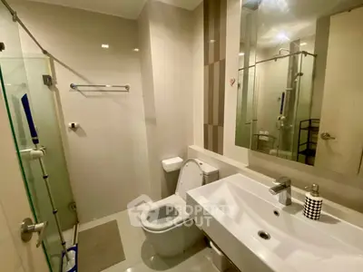 Modern bathroom with sleek fixtures and glass shower enclosure