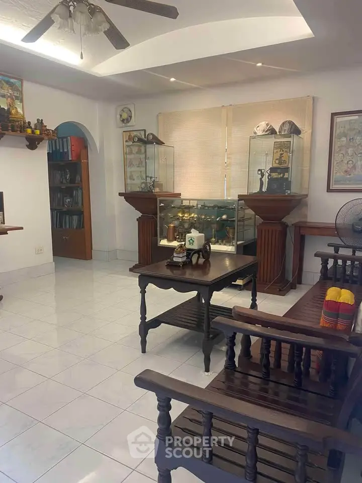 Charming living room with elegant wooden furniture and display cabinets