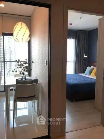 Modern apartment interior with dining area and cozy bedroom, featuring stylish decor and natural light.